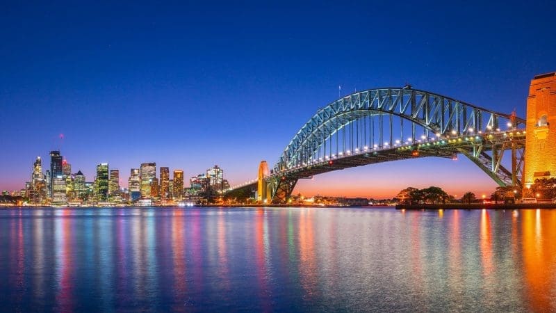 Sydney Harbour Bridge at dusk with shimmering city lights—your gateway to the ultimate 8 Day Sydney to Brisbane Fraser Island tour.